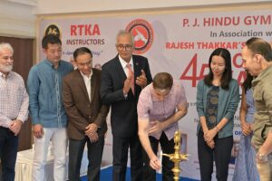 Distinguished guests lighting the ceremonial lamp at the 45th Goju-Ryu Karate Championship at P.J. Hindu Gymkhana, Mumbai