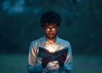 An individual diving deep within a book, seeking knowledge.