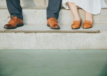 Empowered woman standing confidently with sunrise background