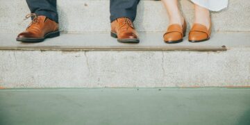 Empowered woman standing confidently with sunrise background